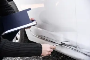 Facharbeiter, der den Schaden eines Fahrzeugs beurteilt